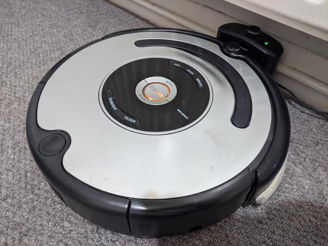 The Roomba docked and charging up